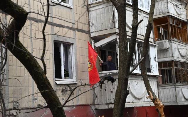 Мэр Белгорода показал фото мужчины с красным флагом на разрушенном балконе